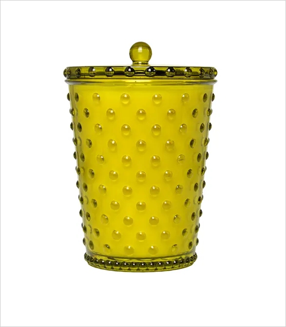 Elegant Simpatico hobnail glass candle in vibrant chartreuse. Handcrafted vessel adorned with raised dots and a matching lid. This American-made luxury features Simpatico's signature paraffin-free wax blend, known for its superior scent throw and clean burn. A perfect fusion of artisanal glasswork and eco-conscious fragrance design.
