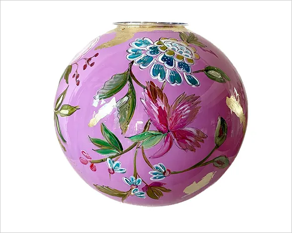 Exquisite hand-painted glass vase by Dutch artist Doortje IJpellar. Spherical 'Grape' vase with vibrant pink background adorned with delicate floral motifs in blues, greens, and reds. Part of a limited series, each piece signed by the artist. A stunning blend of traditional craftsmanship and contemporary design.