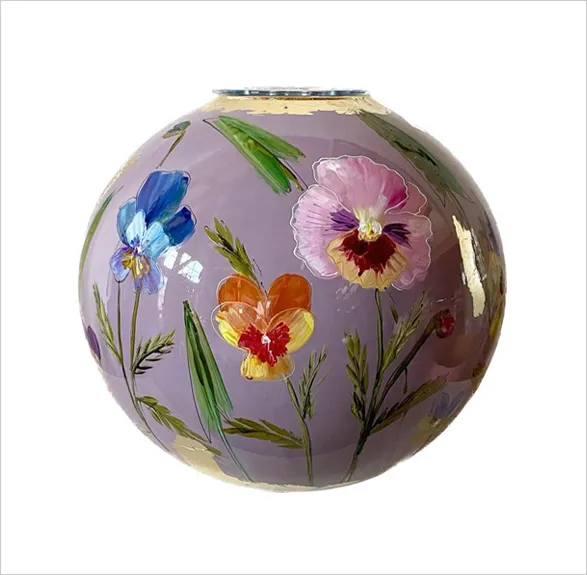 Enchanting hand-painted glass vase 'Mauve' by esteemed Dutch artist Doortje IJpellar. This spherical masterpiece showcases a soft mauve background adorned with vibrant floral artistry - featuring delicate pansies in pink and orange, alongside a striking blue iris. Golden accents highlight the rim and intricate details. A limited edition piece, signed by the artist and crafted in her Netherlands studio, accompanied by a certificate of authenticity.